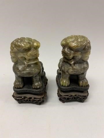 PAIR OF CARVED JADE FOO LIONSOn