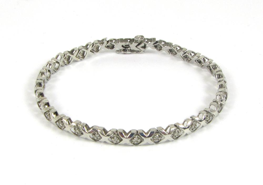 DIAMOND AND WHITE GOLD TENNIS BRACELET.