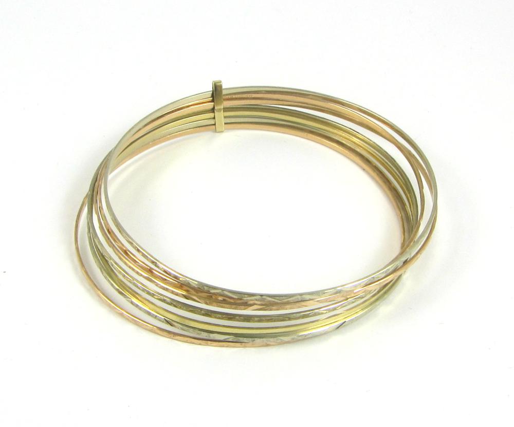 TRI-COLOR FOURTEEN KARAT GOLD SEVEN-BANGLE