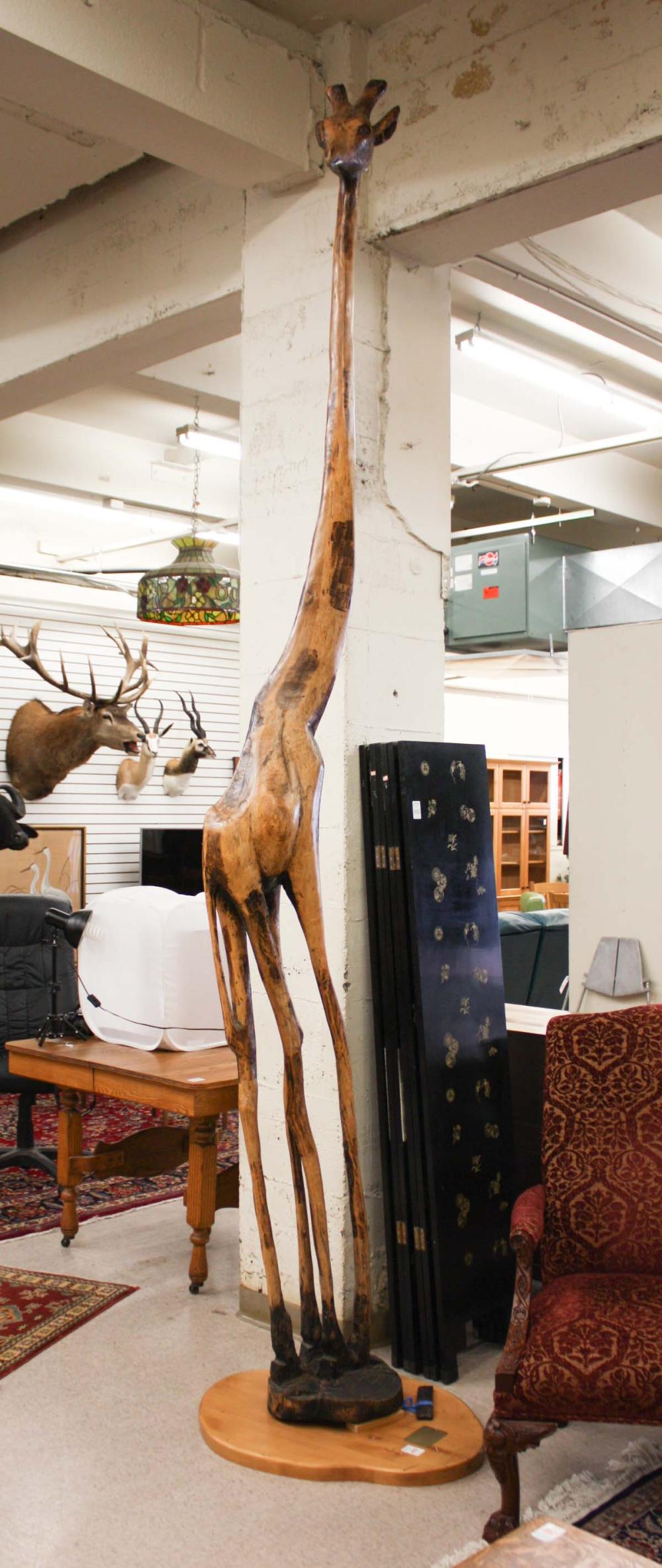 A TALL GIRAFFE WOOD CARVING, "HEMINGWAY,"