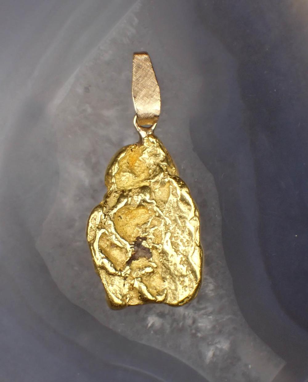 TWENTY ONE KARAT GOLD NUGGET PENDANT,