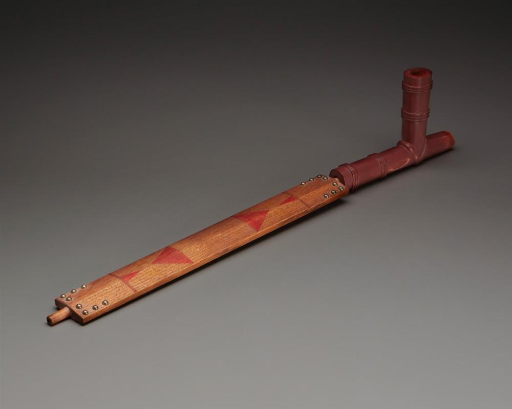 A PLAINS CATLINITE PIPE AND STEMA