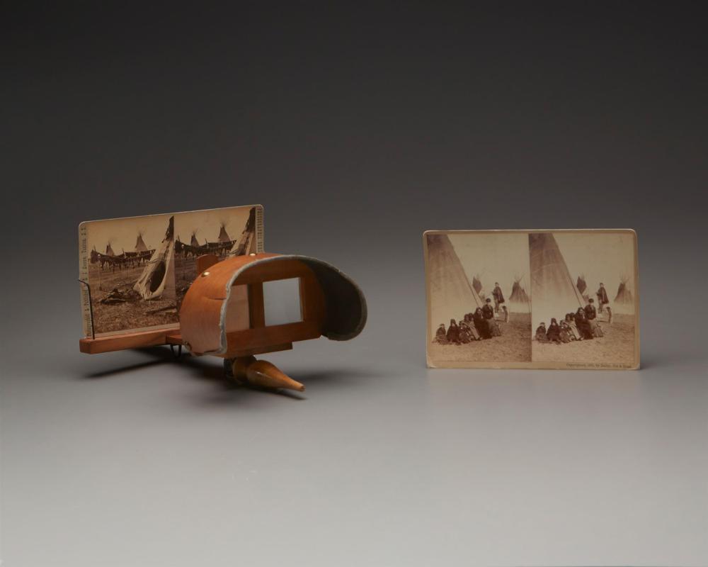 A STEREOSCOPE WITH A GROUP OF STEREOGRAPH