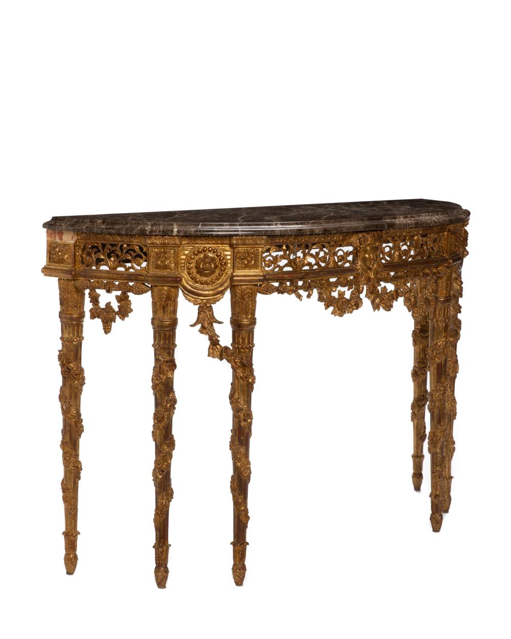 A CONTINENTAL CARVED GILTWOOD DEMI-LUNE