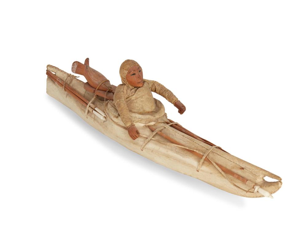 AN ESKIMO INUIT MODEL KAYAK WITH FIGUREAn