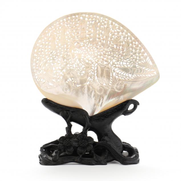 A CHINESE CARVED SHELL ON STAND