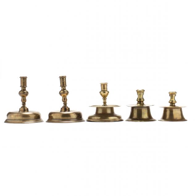 FIVE EARLY CONTINENTAL BRASS CANDLESTICKS