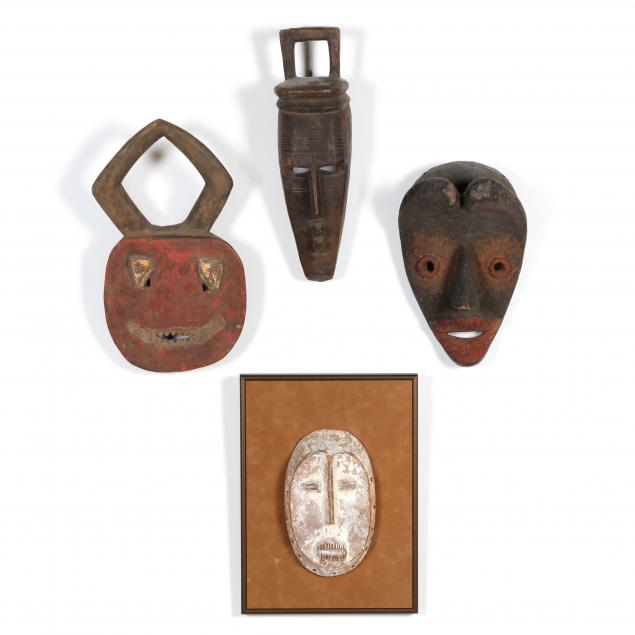FOUR AFRICAN MASKS OF CARVED WOOD