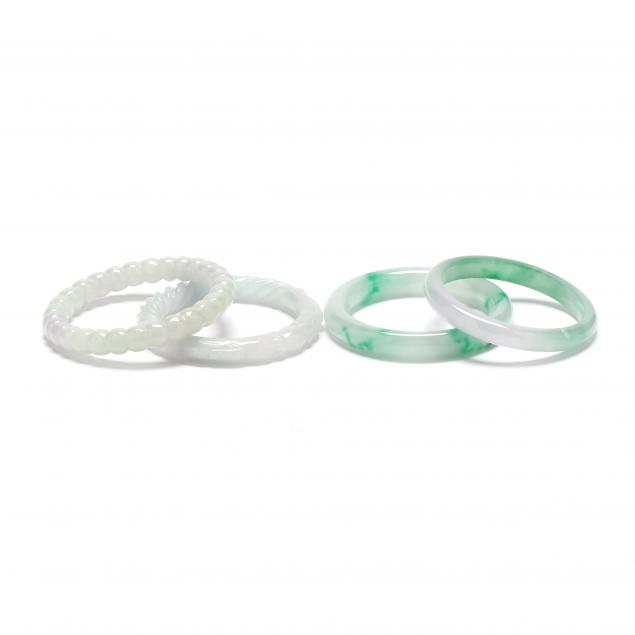 FOUR JADE BANGLES To include a 34763a