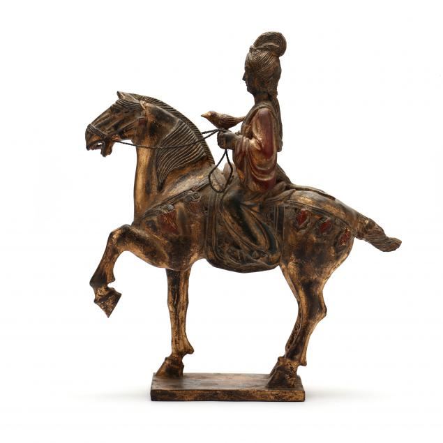 A CHINESE STYLE HORSE AND RIDER SCULPTURE