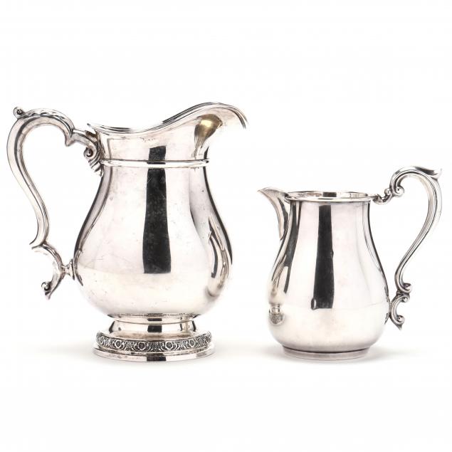 TWO STERLING SILVER PITCHERS The first
