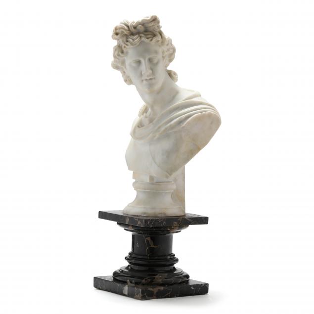 A CARVED MARBLE BUST OF APOLLO