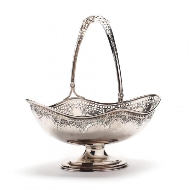 A STERLING SILVER BASKET WITH SWING