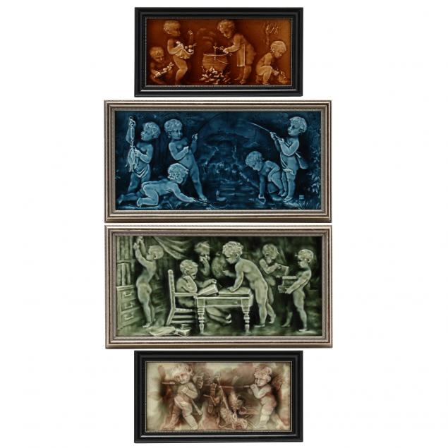 FOUR MAJOLICA TILE PLAQUES OF PUTTI