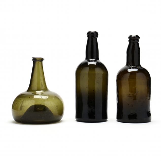 THREE EARLY GREEN GLASS BOTTLES 348003