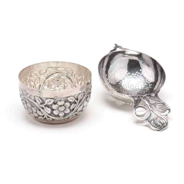 A SILVER TEA STRAINER AND FLORAL