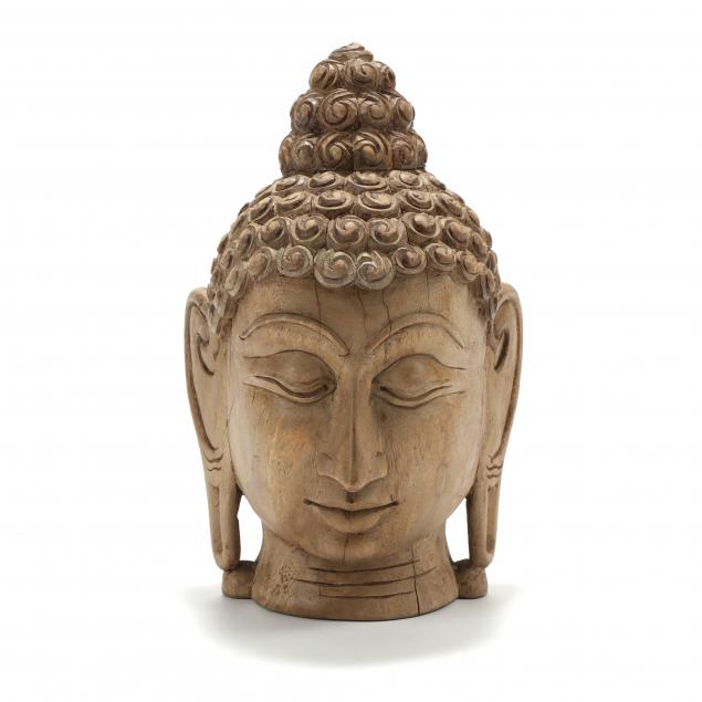 A LARGE THAI CARVED WOODEN HEAD OF BUDDHA