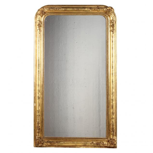 LARGE ANTIQUE CARVED AND GILT MIRROR