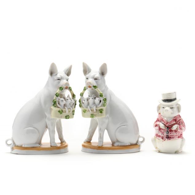THREE PORCELAIN PIGS A Facing pair of