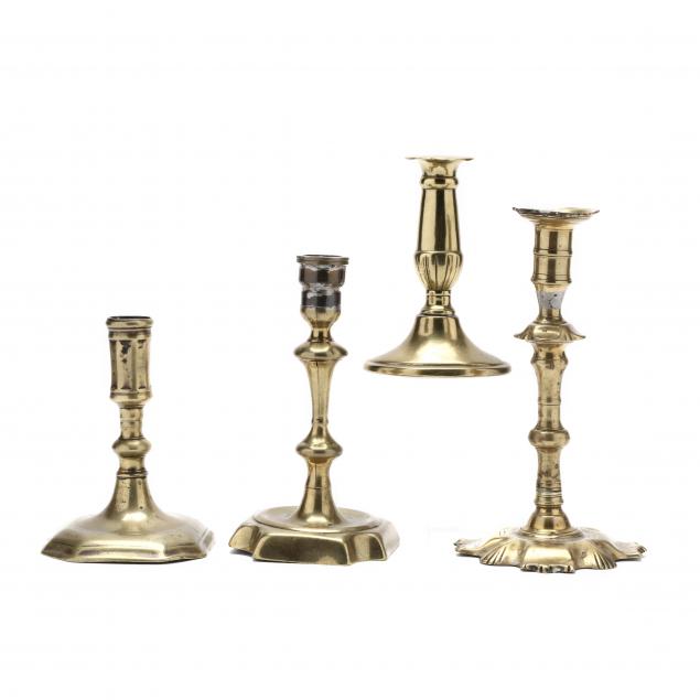 FOUR ANTIQUE BRASS CANDLESTICKS To include