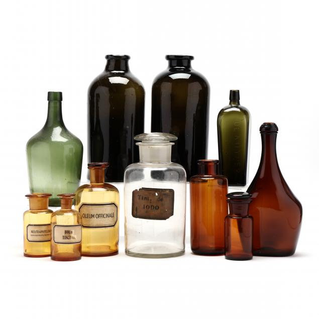 ELEVEN ANTIQUE GLASS BOTTLES AND