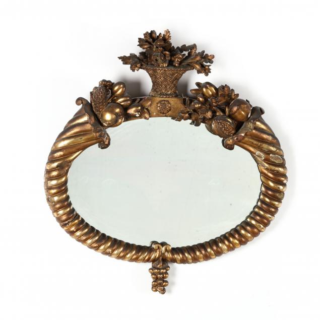 ANTIQUE CARVED AND GILT OVAL MIRROR