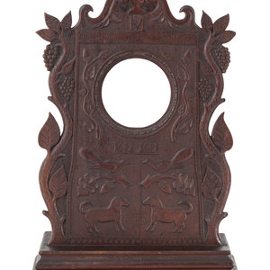 A Carved Walnut Folk Art Clock
