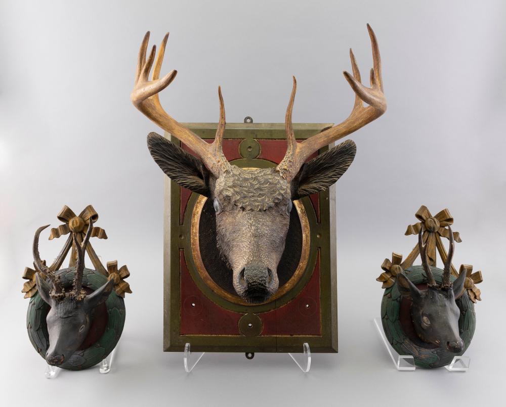 THREE CARVED WOODEN STAG HEADS 34fc2a