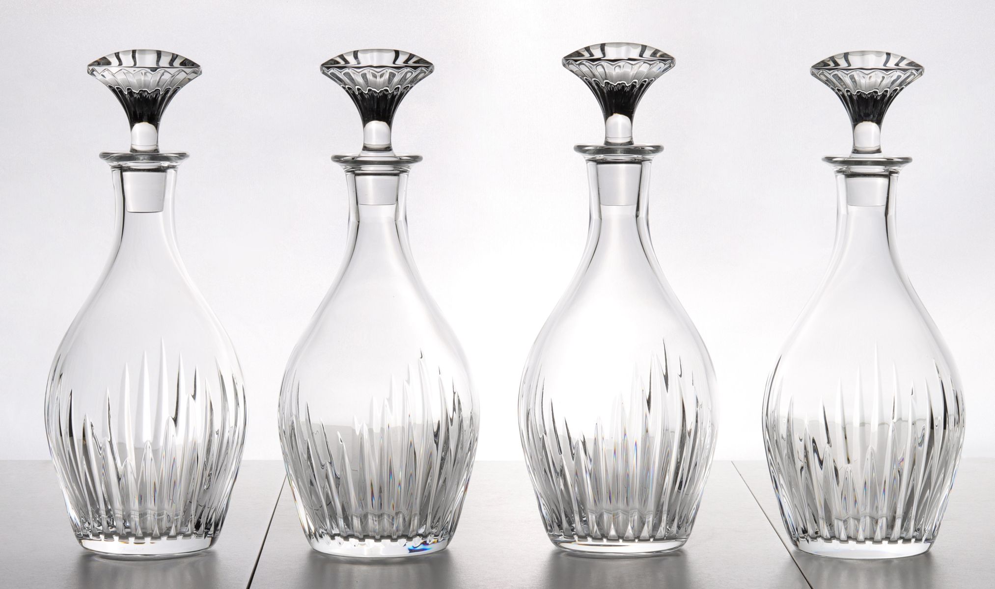 FOUR FRENCH CUT CRYSTAL DECANTERS