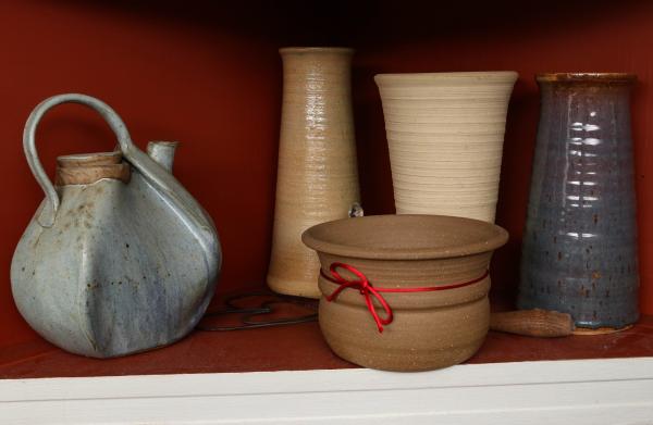 TWO SHELVES OF STUDIO POTTERY AND