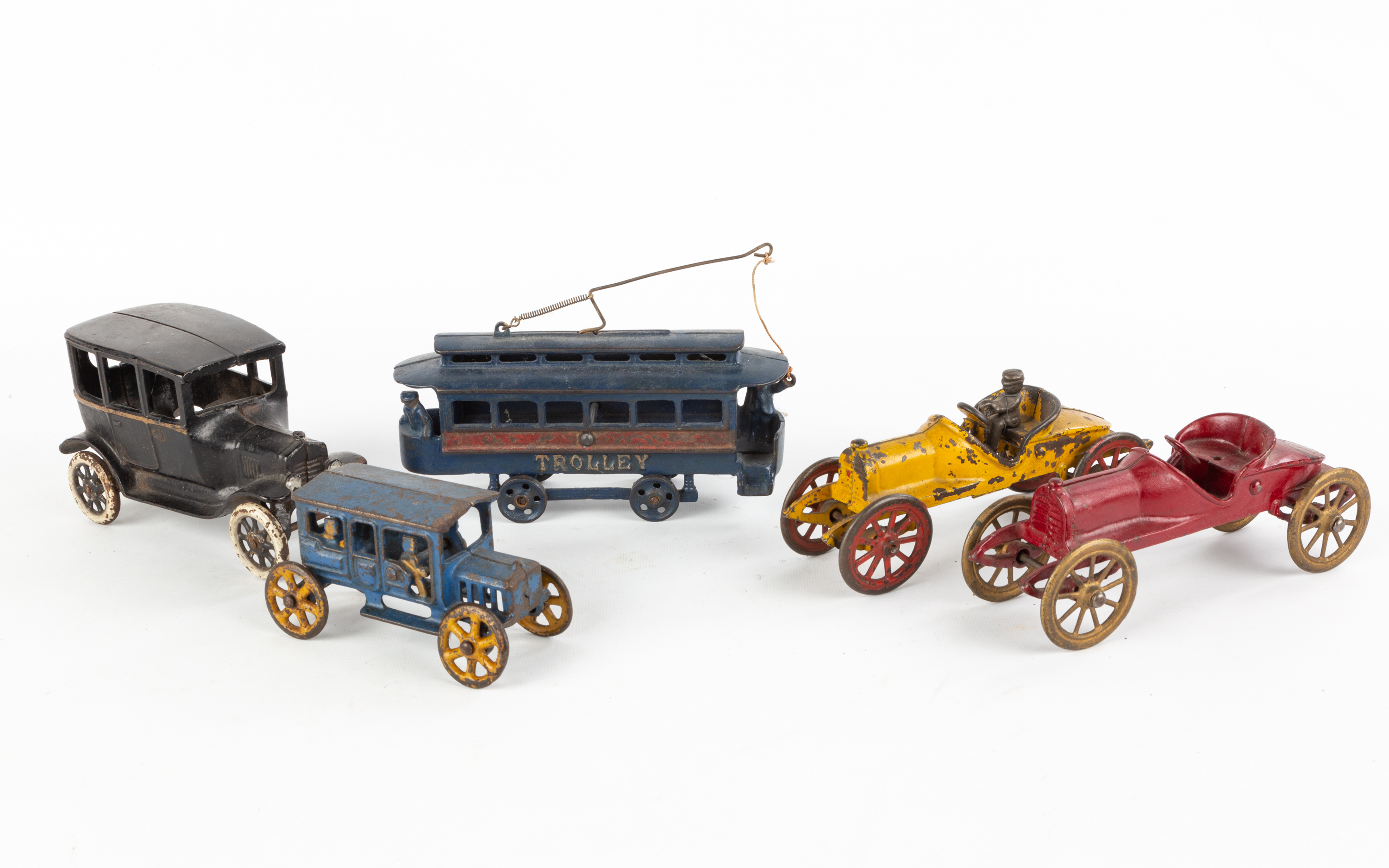 GROUP OF CAST IRON CAR AND TROLLEY TOYS