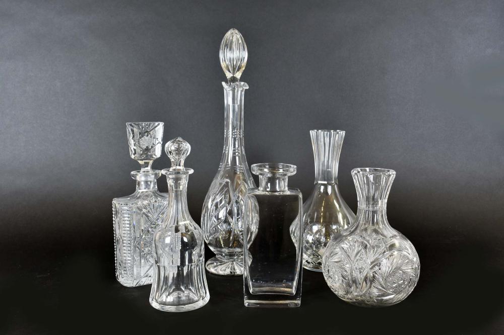 SIX VARIED COLORLESS GLASS DECANTERSUnsigned.