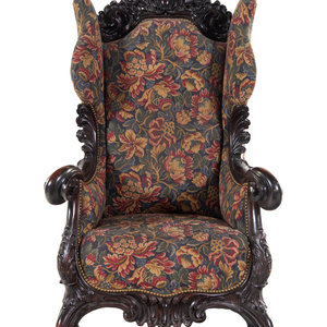 A Karpen Carved Mahogany Wingback Armchair
Late