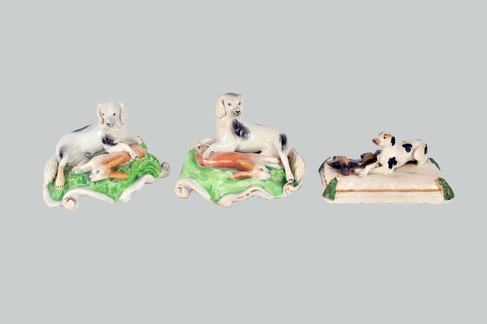 THREE PAINTED CERAMIC HUNTING DOGS WITH