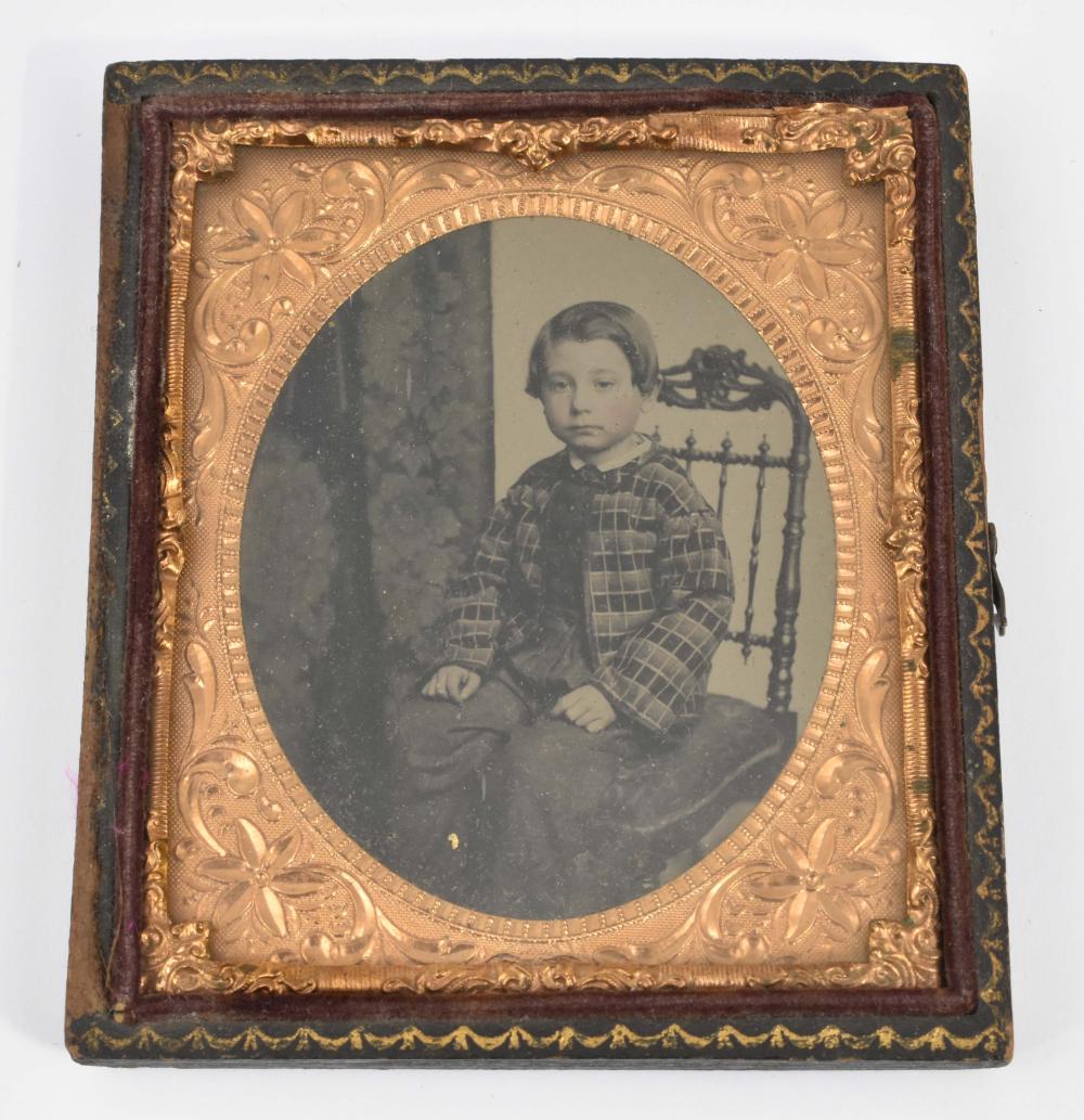 AMBROTYPE OF A BOY SEATED ON A