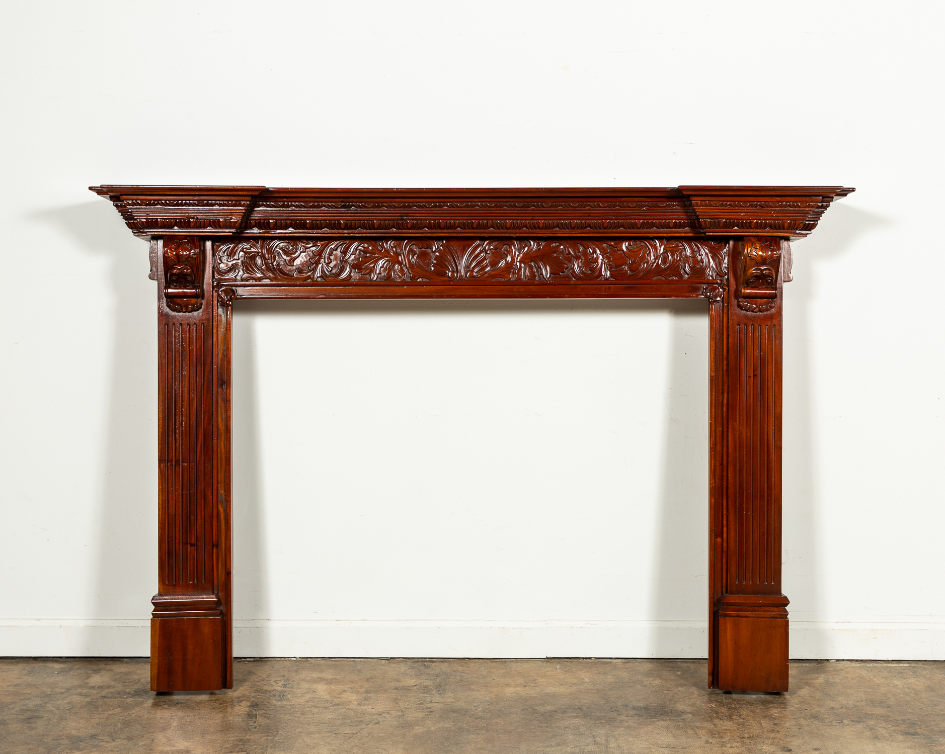 CARVED NEO-BAROQUE MAHOGANY FIREPLACE