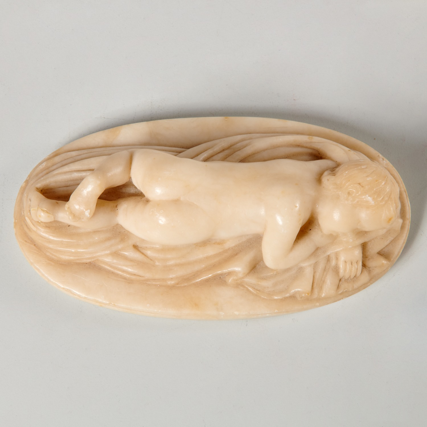 ALABASTER CARVING OF A YOUNG BOY