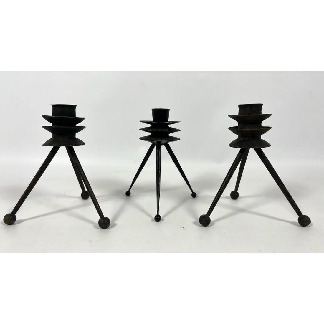 Trio of TONY PAUL Black Iron Candlesticks.