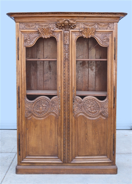Large carved wood armoire with