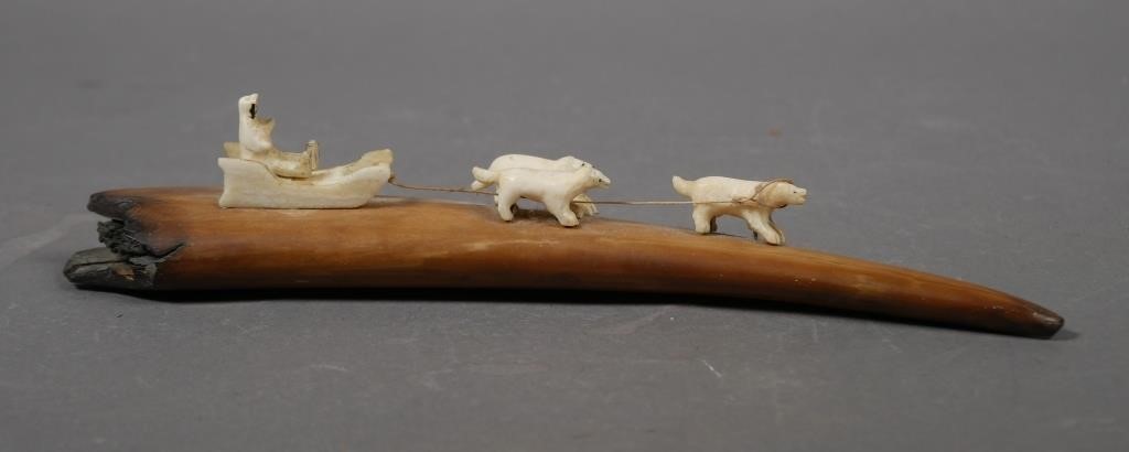 INUIT CARVED DOG SLED ON WALRUS FOSSIL