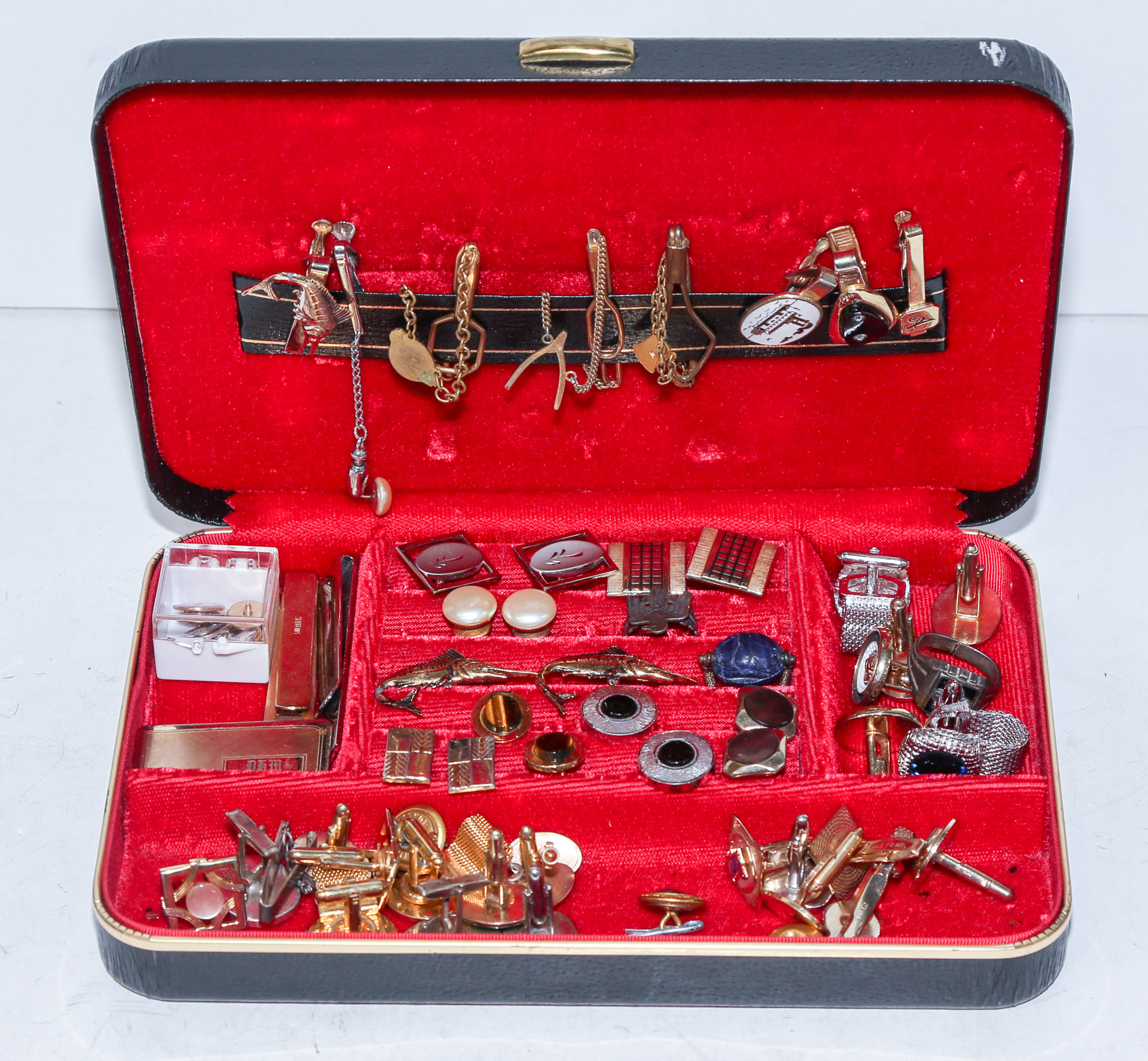 A JEWELRY BOX FILLED WITH CUFFLINKS