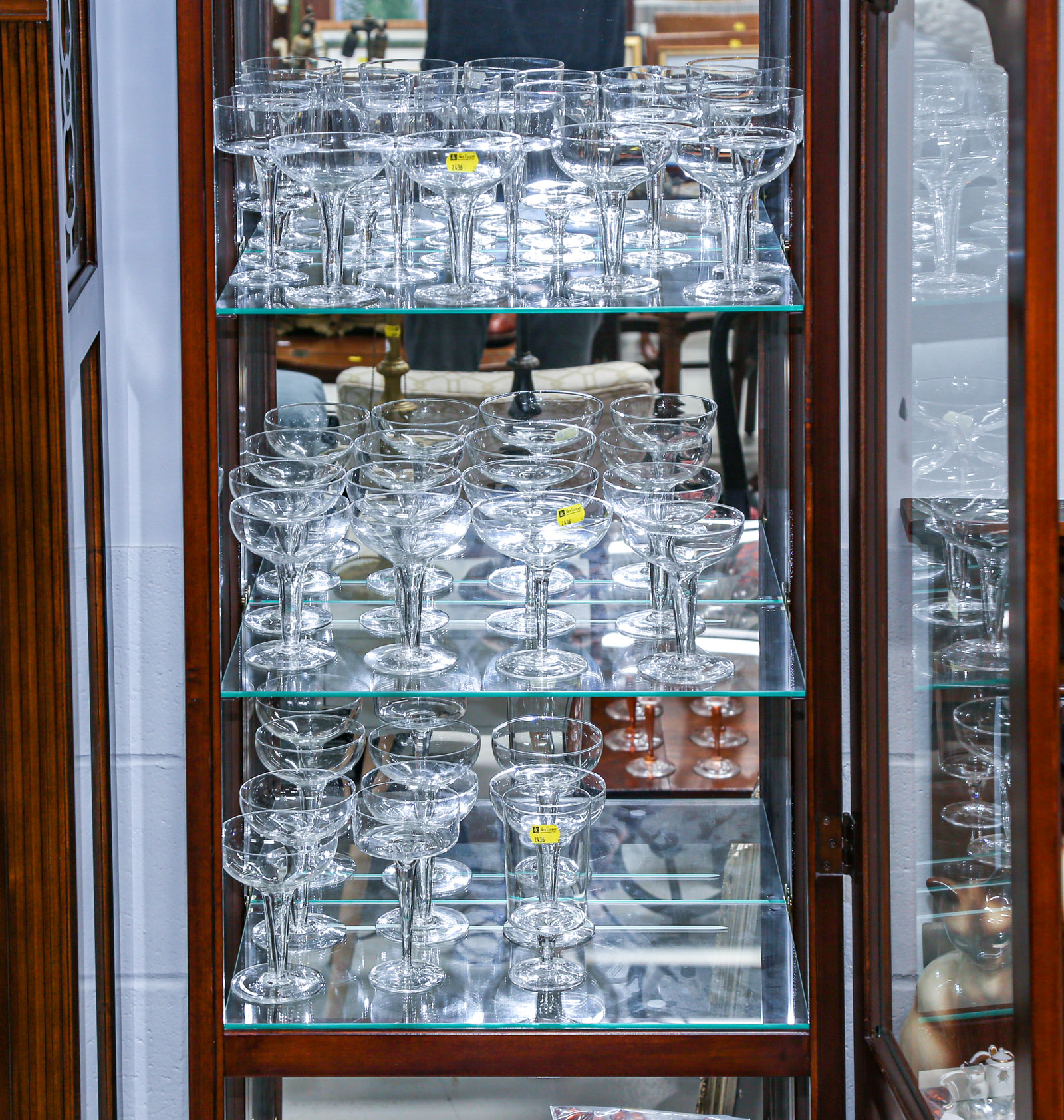 THREE SHELVES OF STEMWARE .