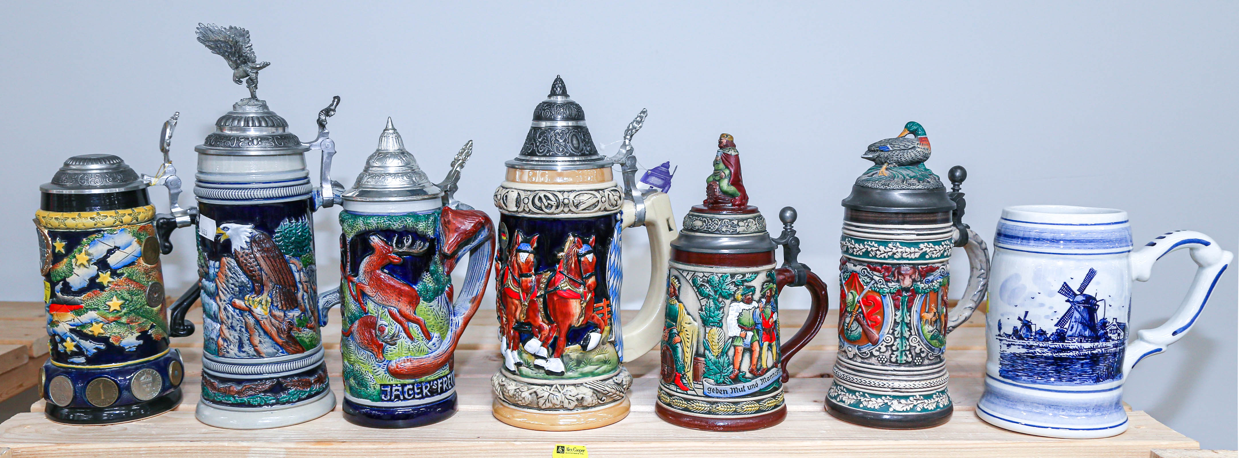 SEVEN ASSORTED GERMAN BEER STEINS .