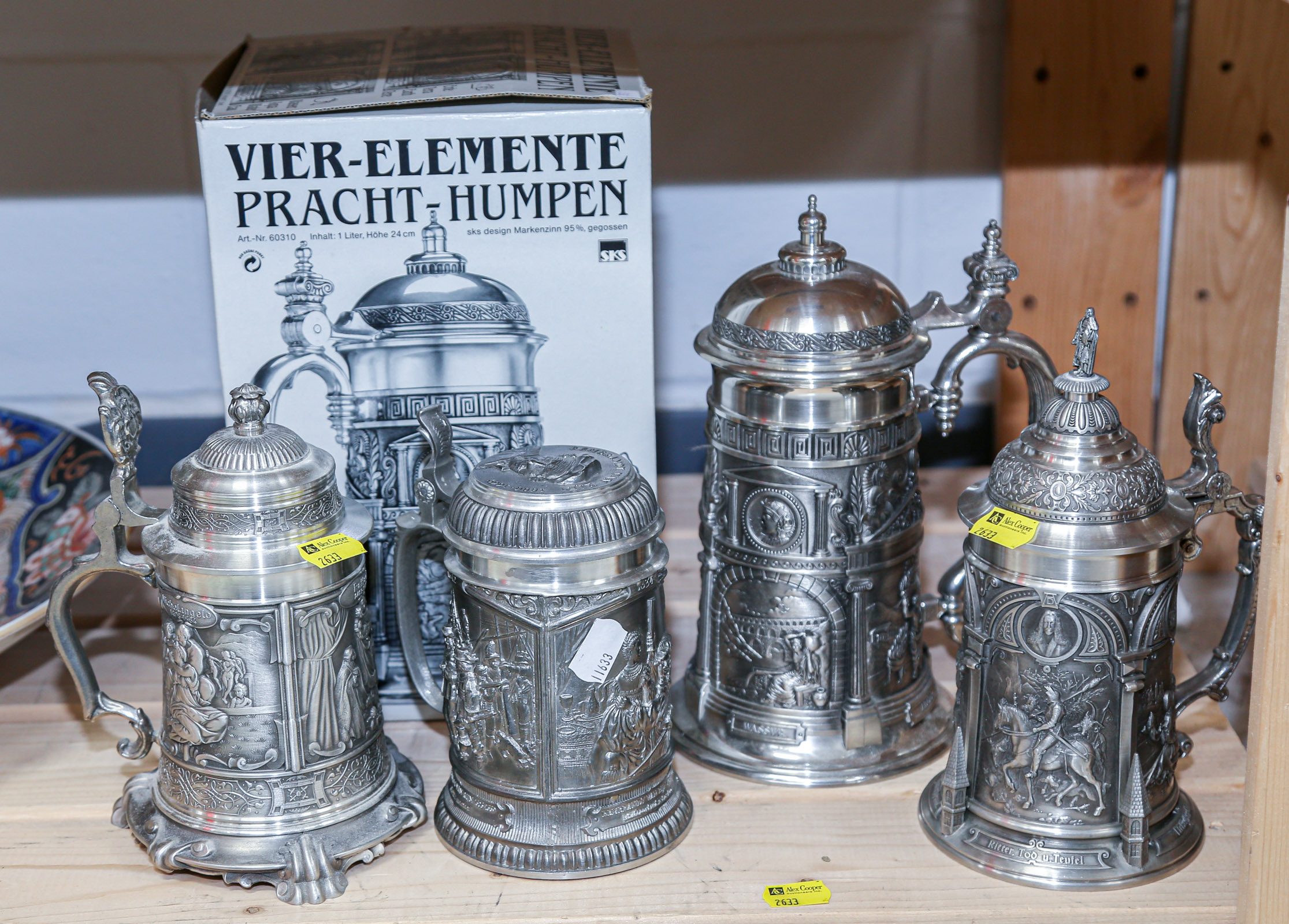 FOUR ORNATE GERMAN PEWTER STEINS One