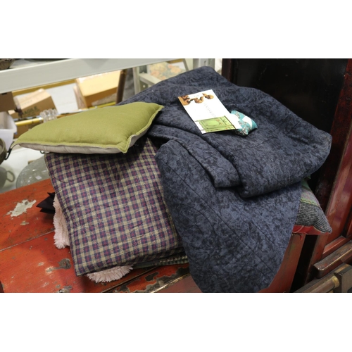 An array of bedspread, cushions
