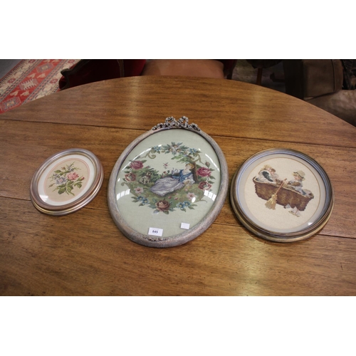 Three oval framed needleworks,