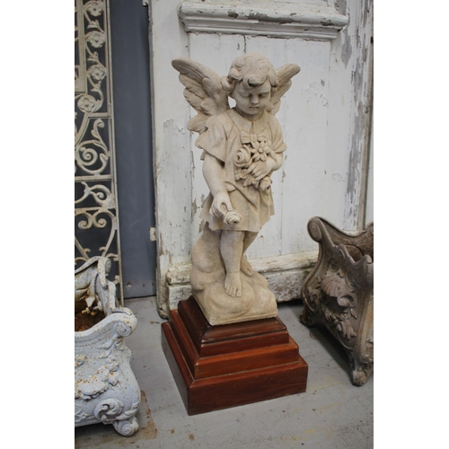 Statue angel child on wooden pedestal,