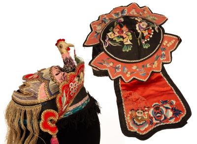 A Chinese embroidered hat, decorated