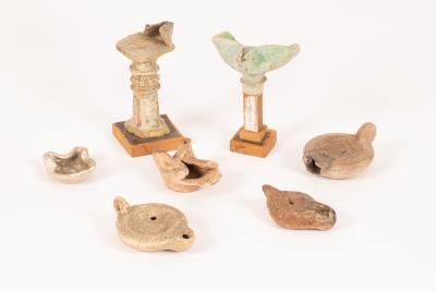 Three Roman pottery oil lamps and four