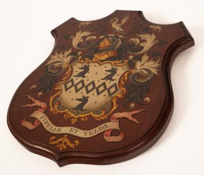 A painted wooden armorial shield